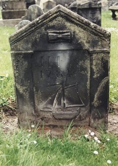 Tulliallan, Old Parish Church, burial ground.
General view of gravestone with hourglass and sailing ship.
Insc: 'J.H. 1784'.