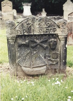 Tulliallan, Old Parish Church, burial ground.
General view of gravestone with the figure of a boatbuilder, sailing boat, hourglass, skull and crossed bones. Scrolling pediment.
Insc: '17.29 D.P.18.T.P'