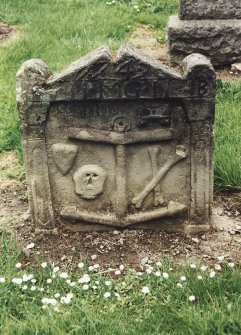 Tulliallan, Old Parish Church, burial ground.
General view of gravestone with anchor, skull, crossed bones, hourglass and heart, below pediment.
Insc: '1742. I.I.M.G.I.I.B'.
