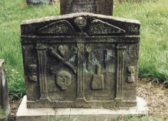Tulliallan, Old Parish Church, burial ground.
General view of gravestone with winged soul above three pilasters dividing hourglass, heart and crossed bones and skull; chisel, mallet and pick; and another hourglass.
Insc: '1742, W.B.H'