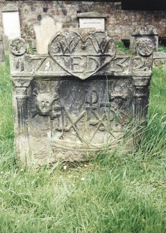 Tulliallan, Old Parish Church, burial ground.
General view of gravestone with pilasters, rosettes, and large central heart. Skull and crossed bones and sailing ship.
Insc: 'W.W. E.D' (in heart) and '1732'.
