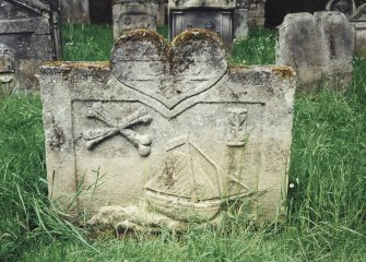Tulliallan, Old Parish Church, burial ground.
General view of gravestone, with large heart, with crossed bones, hourglass and sailing ship on a sculptured 'sea'.
Insc: '1727. A.C.W.M.S'