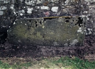 View of grave slab mounted on wall.