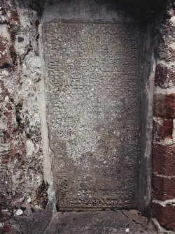 Detail of grave slab mounted in wall.