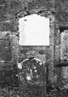 View of headstone and wall plaque.