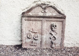 Glendevon Parish Church, Churchyard.
General view of tombstone with scales and merchant's '4'sign, skull, crossed bones and hourglass.
Insc:'1716. Memento Mori. A.F. I.F'.