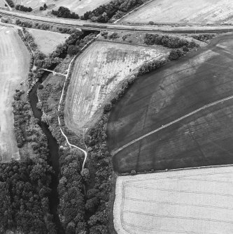 Inveresk: oblique air photograph of Roman temporary camps, enclosure, soilmarks, long cist cemetery and mineral railway