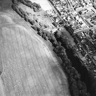 Milton and Friockheim, oblique aerial view, taken from the W, centred on the cropmarks of a pit-defined cursus, pit-alignments and pits.