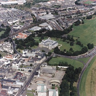 Oblique aerial view of Edinburgh centred on Holyrood Palace and Abbey, taken from the SW.