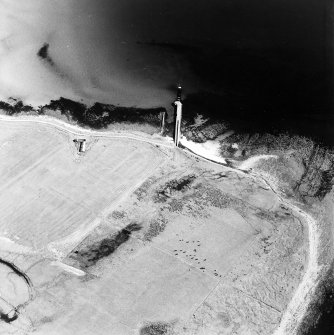 Oblique aerial view of Orkney, Swanbister House, part of the First World War seaplane base, taken from the SW.  Visible is the Royal Navy aircraft loading pier and former landing strip area.  Also visible is the Second World War radio beacon mast base.