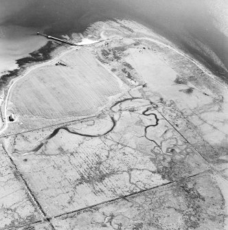 Oblique aerial view of Orkney, Swanbister House, part of the First World War seaplane base, taken from the WNW.  Visible is the Royal Navy aircraft loading pier and former landing strip area.
