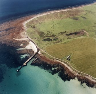 Oblique aerial view of Orkney, Swanbister House, First World War seaplane base, taken from the NE.  Visible is the Royal Navy pier and former landing strip.