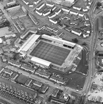 Oblique aerial view centred on the football stadium, taken from the SSE.