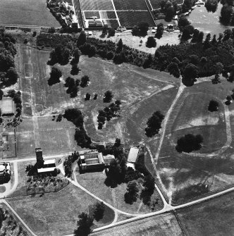 Oblique aerial view from North of Gordon Castle estate (after demolitions), including tower, home farm and cropmarks