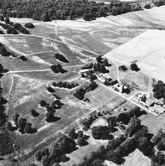 Oblique aerial view from South East of Gordon Castle estate (after demolitions), including house, tower, home farm, Wilderness and cropmarks