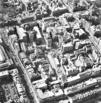 Oblique aerial view showing area surrounding Cowgate, including Chambers Street to left of photograph, George IV Bridge at top, High Street to right, and South Bridge to bottom