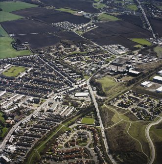 Oblique aerial view centred on the village, miners¿ rows and colliery, taken from the NW.