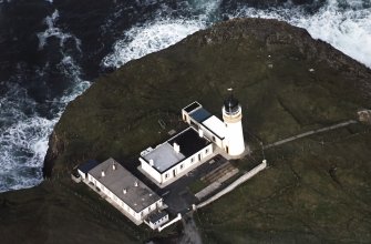Oblique aerial view centred on the lighthouse and keepers cottages, taken from the SSW.