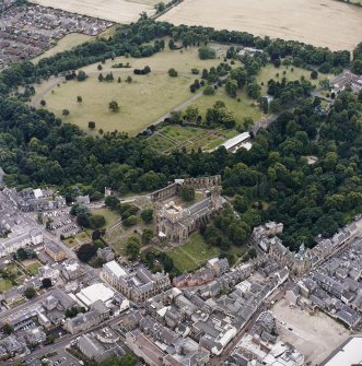 Oblique aerial view centred on the abbey, with the town hall, library and Abbots House adjacent, taken from the NE.