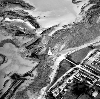 Oblique aerial view centred on the lighthouse with village adjacent, taken from the NNE.