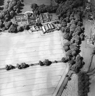 Oblique aerial view centred on the cropmarks of the possible unenclosed settlement, rig, and linear cropmarks with the country house, farmsteading, garden, walled garden and gate piers adjacent, taken from the E.