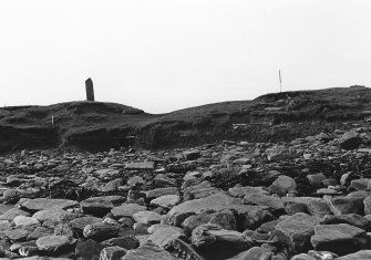 Photograph showing coastal erosion of structural features.