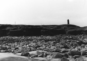 Photograph showing coastal erosion of structural features.