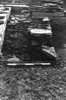 Excavation photograph : east range - feature outside room 4, from north.
