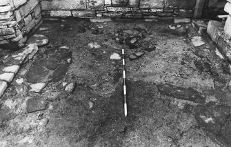 Excavation photograph : south range - room 4 floor, from west.