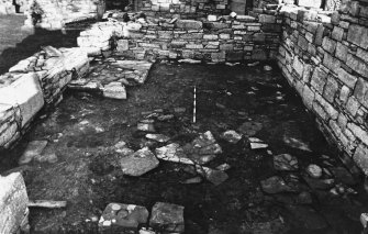 Excavation photograph : east range - room 2 floor, from south.