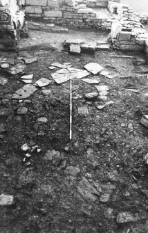 Excavation photograph : east range - room 2 floor, from north.