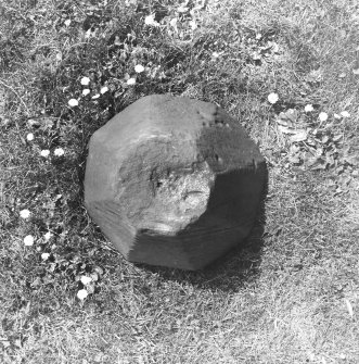 Excavated carved stone displayed in churchyard.