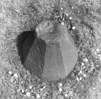 Excavated carved stone displayed in churchyard.