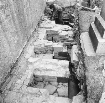 Excavation trench along side of church.
