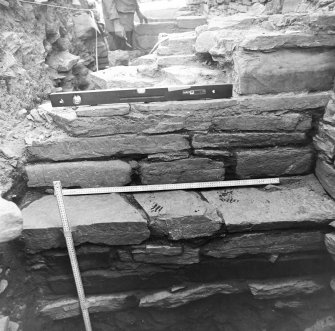 Excavation trench along base of church.