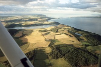 An oblique aerial view of Munlochy Bay and along the south coast of the Black Isle, looking NE.
