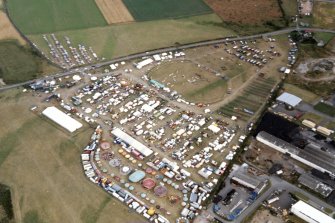 An oblique aerial view of the Black Isle Showground, Muir of Ord, Urray, Ross and Cromarty, looking SE.