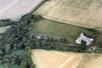 An oblique aerial view of Poyntzfield Mills, Resolis, Black Isle, looking SE.