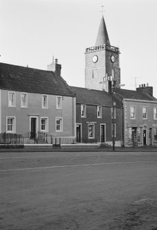 View of 71-75 George Street, Whithorn, with Old Town Hall steeple in the background, from south east.