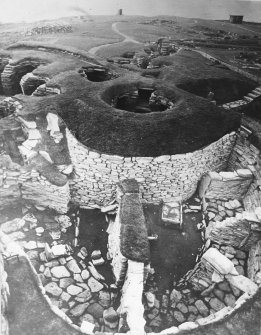 Publication Photograph: Aisled roundhouse and wheelhouses in broch courtyard with passage house in flanking mound.