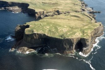 Oblique aerial view of Staffa, with Fingal's Cave, looking NE.