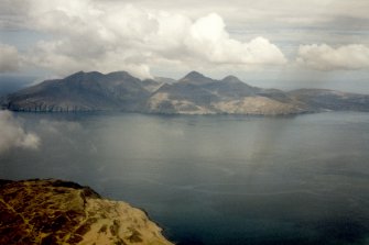 Oblique aerial view from Eigg (near Bay of Laig) to the Isle of Rum, looking NW.