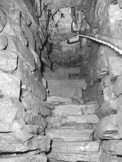 View up lower flight of steps from cistern to half-landing, after installation of handrail.