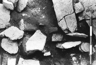 Excavation photograph : trench H - detail of vertical flags L258 (2 removed).

(see MS/682/120 for detailed description)