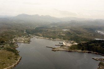 Oblique aerial view of Lochinver, Sutherland and surrounding Assynt area, looking E.