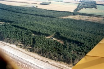 Oblique aerial view of Innes Links and Lossie Forest, Moray, looking S.