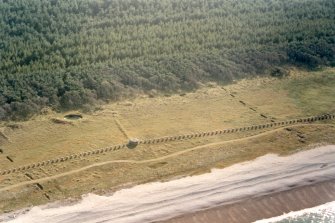 Near vertical aerial view of pillbox and anti-tank blocks at Innes Links, Moray, looking SW.