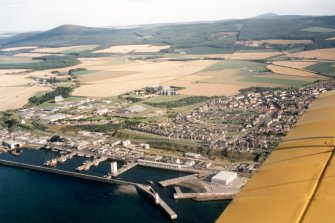 Oblique aerial view of Buckie and hinterland, Moray, looking SE. 