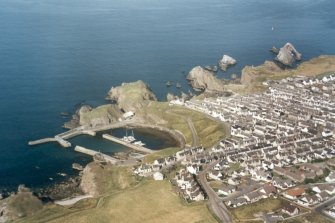 Oblique aerial view of Portknockie and the Bow Fiddle Rock, Moray, looking NE. 