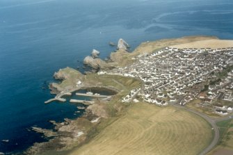 Oblique aerial view of Portknockie and the Bow Fiddle Rock, Moray, looking NE. 